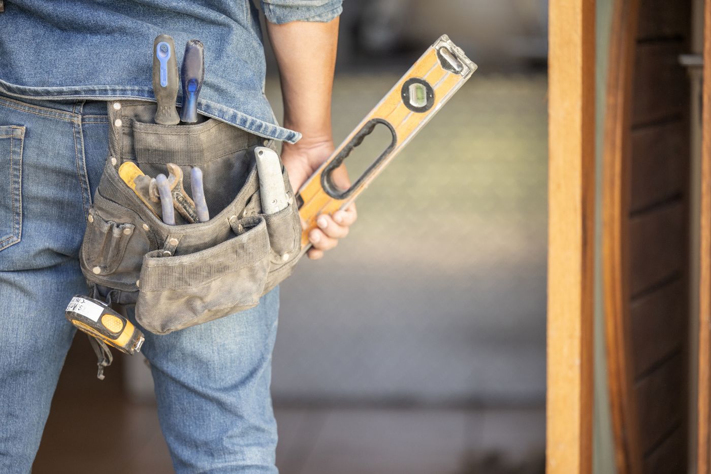 Professional maintenance worker with tools showing compliance and safety inspection